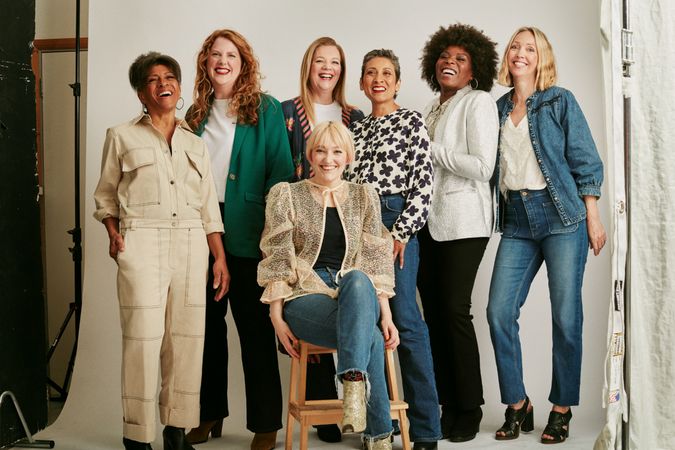 Diverse group of stylish older women standing and sitting for studio portrait