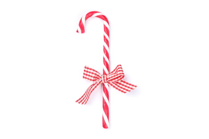 Sweet candy cane with bow isolated on studio background