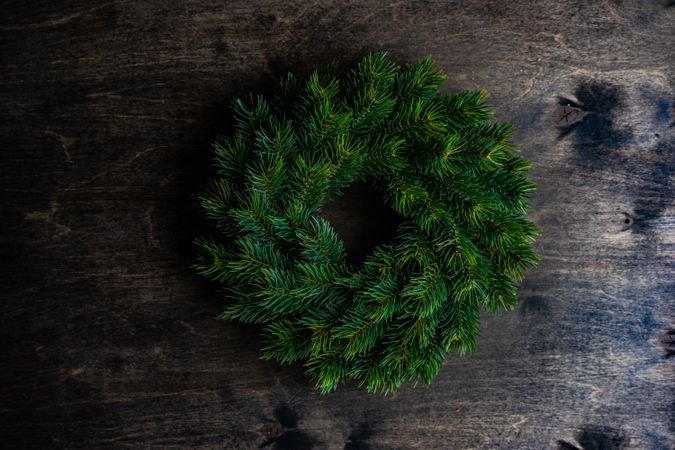 Fir branch wreath on wooden table