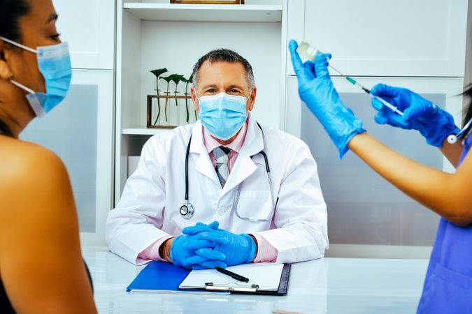 Medical assistant prepping vaccination for patient in doctor’s office