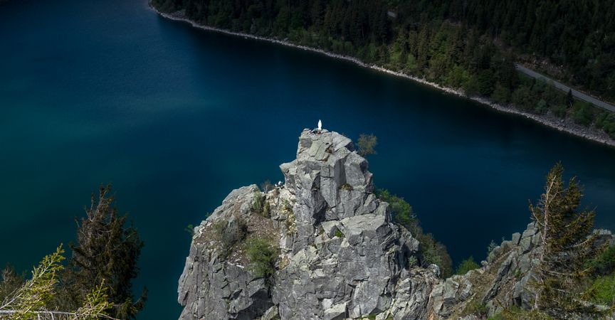 Looking down at religious statue of Virgin Mary overlooking a lake
