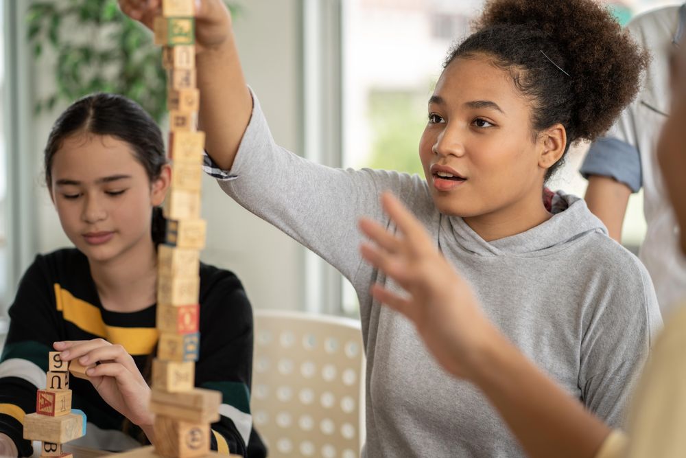 Two female students using building blocks in class
