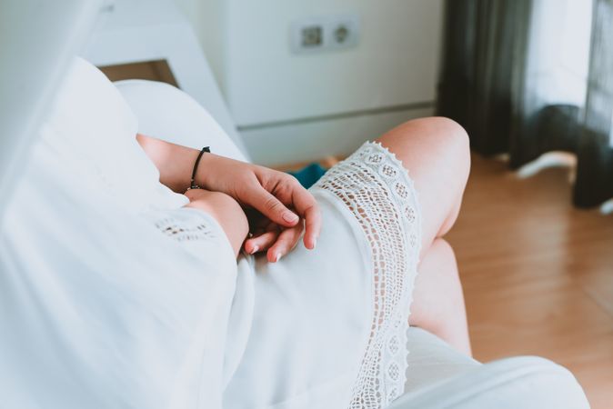 Woman in dress sitting in room