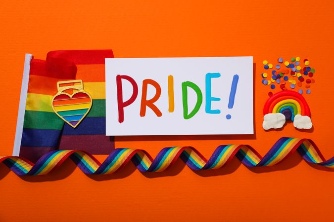 Pride parade concept, symbols on orange background.