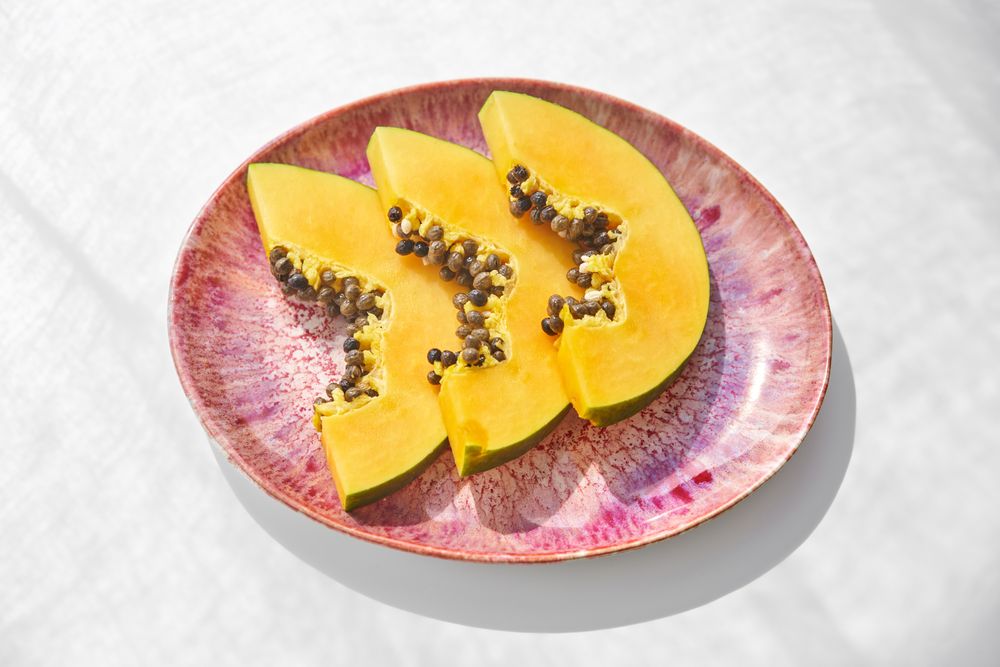Plate with sliced juicy papaya