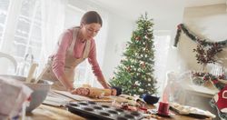Portrait of Female Making Gingerbread Cookies for Christmas at Home.