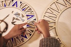 Black woman working with pliers when assembling a frame