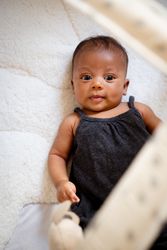 Cute female baby lying on her back, vertical