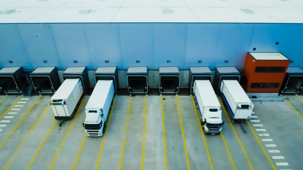 Trucks Precisely Dock at a State-of-the-art Warehouse, Enhancing Logistics Efficiency With Synchronized Cargo Operations.