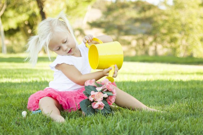 Cute Little Girl Playing Gardener with Her Tools and Flower Pot.