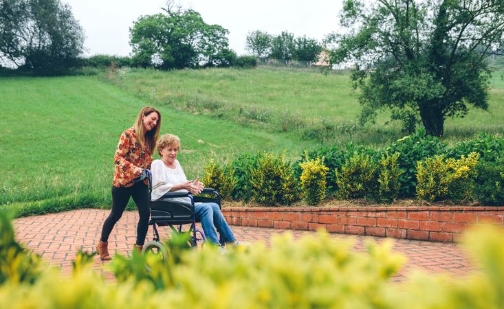 Woman helping her mother in a wheelchair
