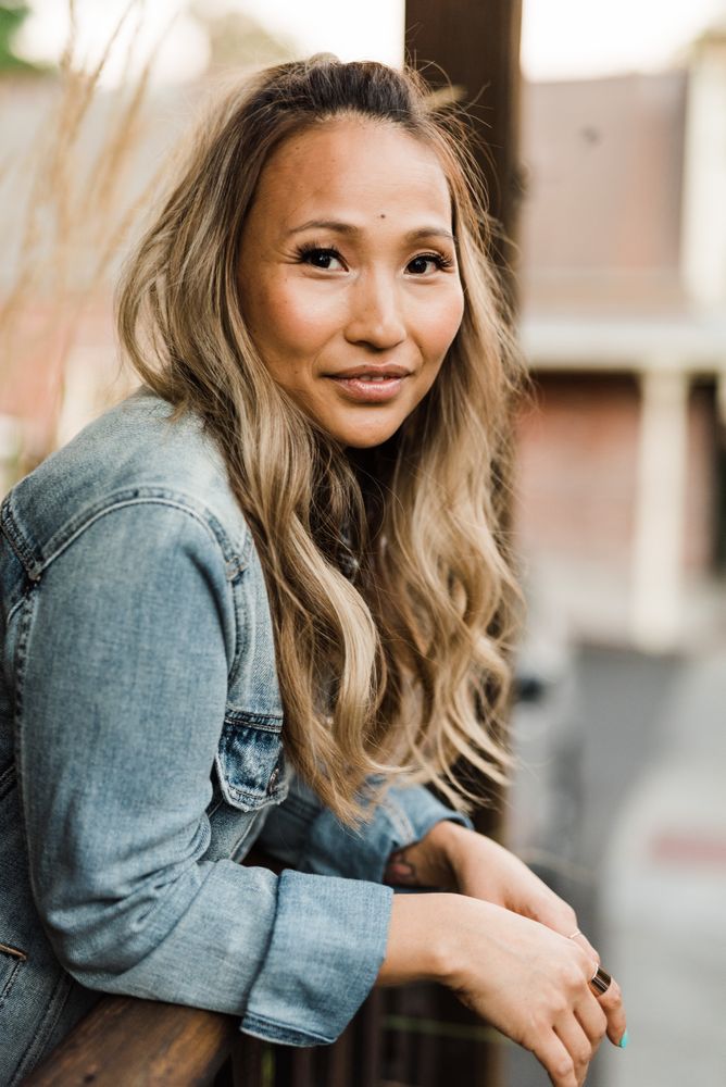 Woman in blue denim jacket smiling