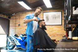 Smiling bearded man receiving a haircut in a salon 48DVv4