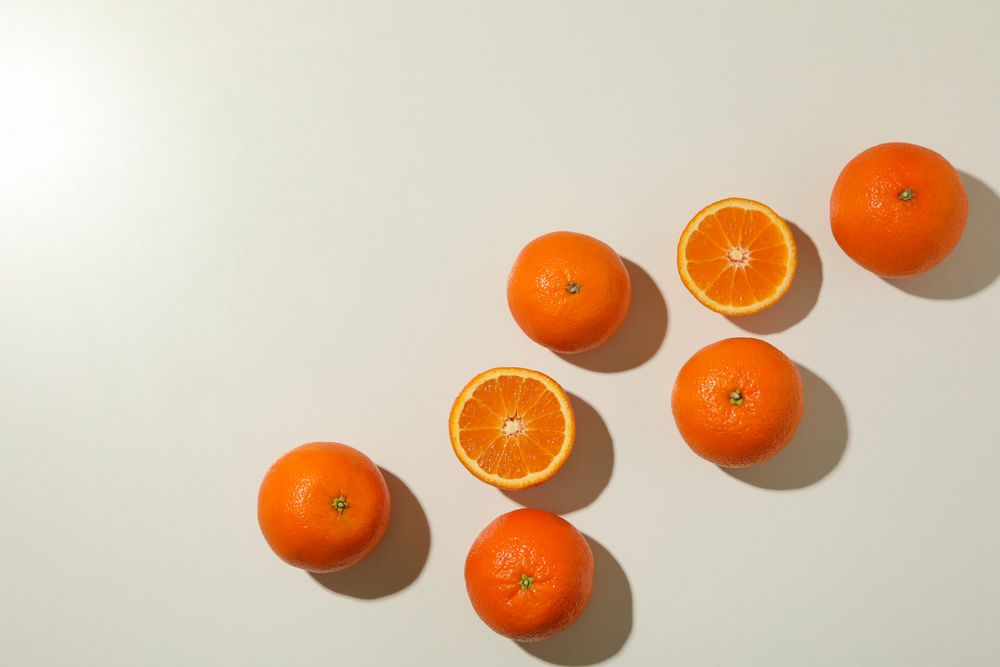 Ripe sweet mandarins on light background, top view