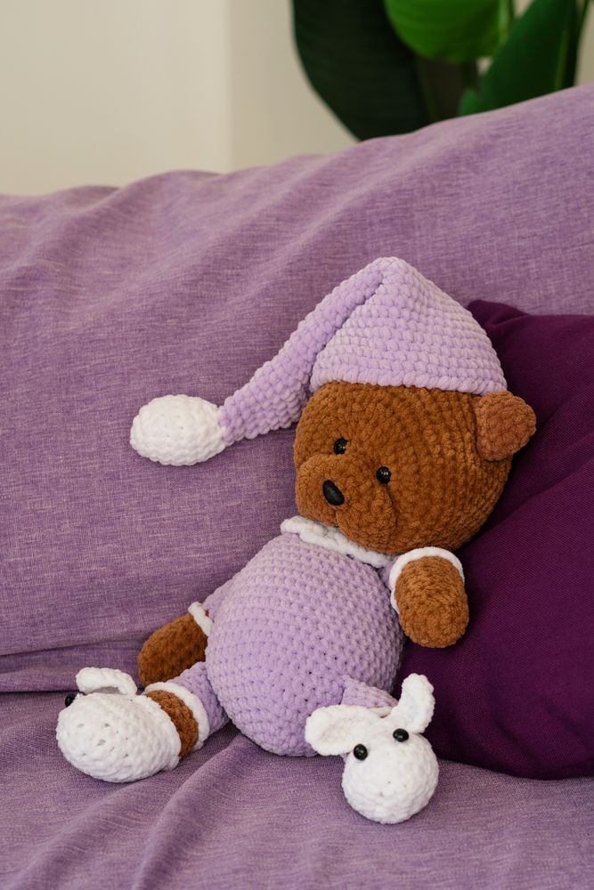 Crochet teddy bear in a knitted outfit