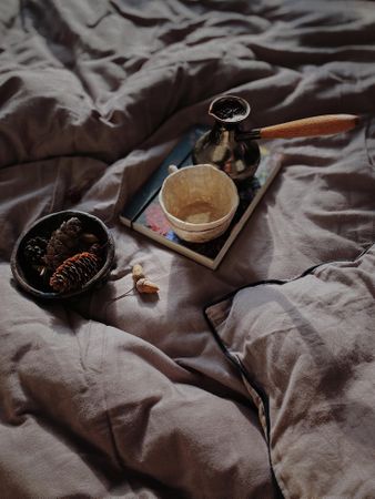 Turkish coffee on notebook on grey bedsheets