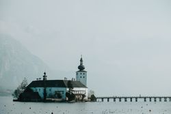 church in calm water surrounded by mountains