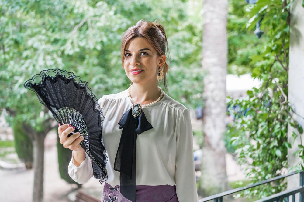 Woman with retro fan in park