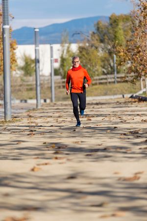 Man running through park on chilly autumn day