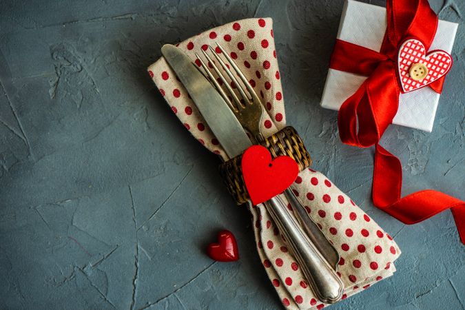 St. Valentine day table setting with dotted napkin wrapped silverware