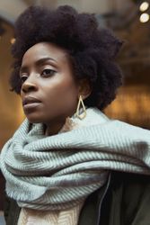 Portrait of Black woman in gray scarf looking away