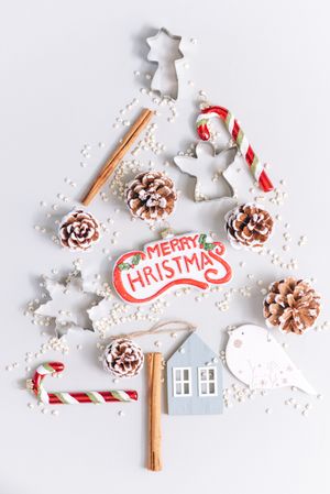 Top view of Christmas desserts and ornament on light background