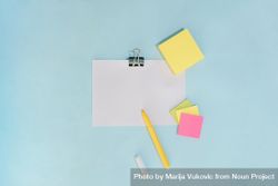 Flat lay of pens and note pad paper on blue background 481mXb