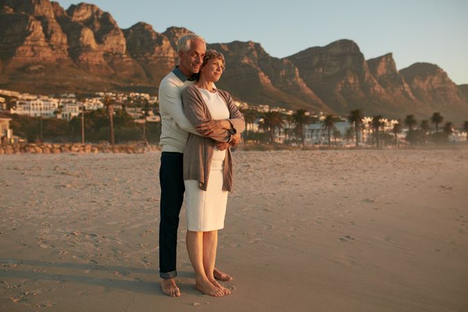 Full length shot of romantic  couple embracing on the sea shore
