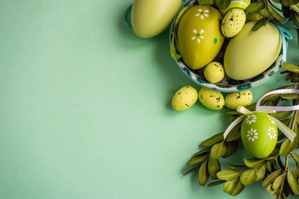 Easter card concept with green decorative Easter eggs in bowls