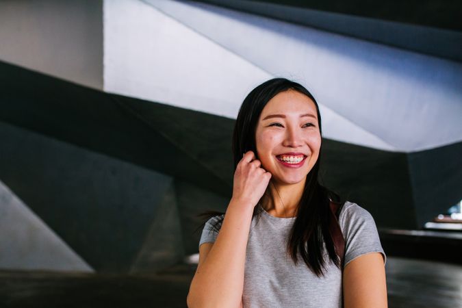 Cheerful Asian woman looking away