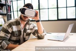 Man in bright modern office in VR headset 4jkrvb