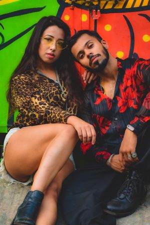 Man and woman in in casual outfits posing