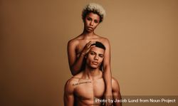 Curly haired woman standing behind muscular man 43lXZb
