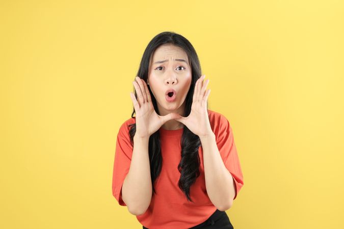 Young Asian Woman Shout Story or making Announcement with Surprised Face