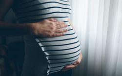 Pregnant woman holding her tummy