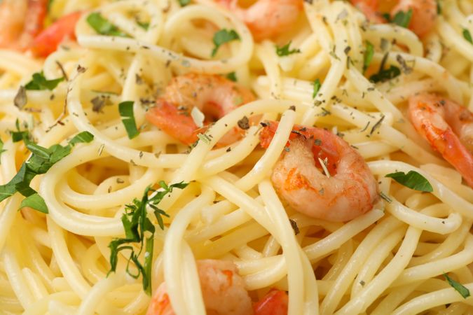 Tasty pasta with shrimps on whole background, close up