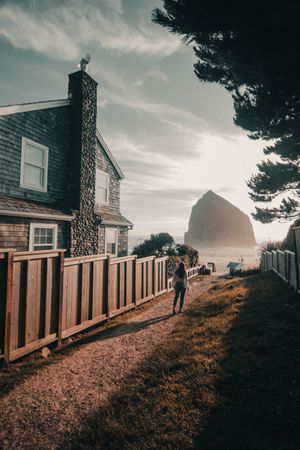 Person standing beside house during golden hours
