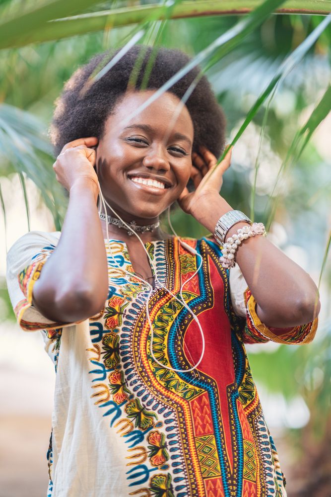 Smiling Black woman listening to music