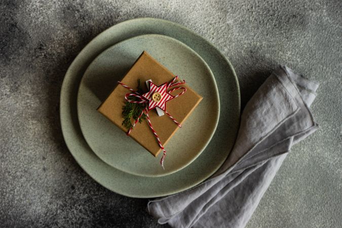 Brown presents with string and name card on table setting