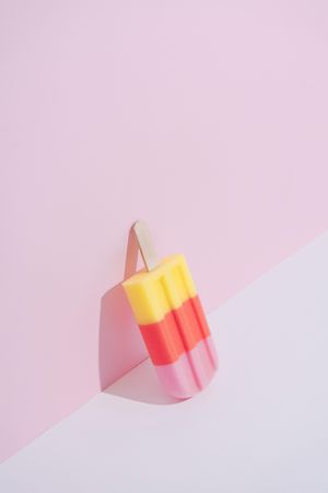 Colorful ice cream popsicle on pastel pink background