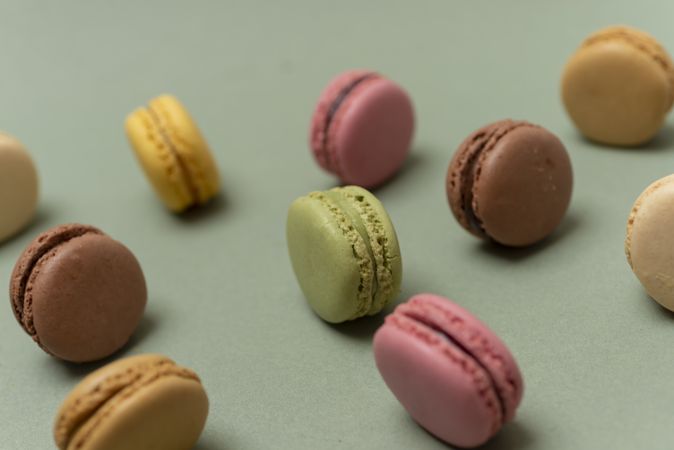 Colorful tasty  macaroons over a green background