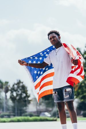 Black man in American Flag outside