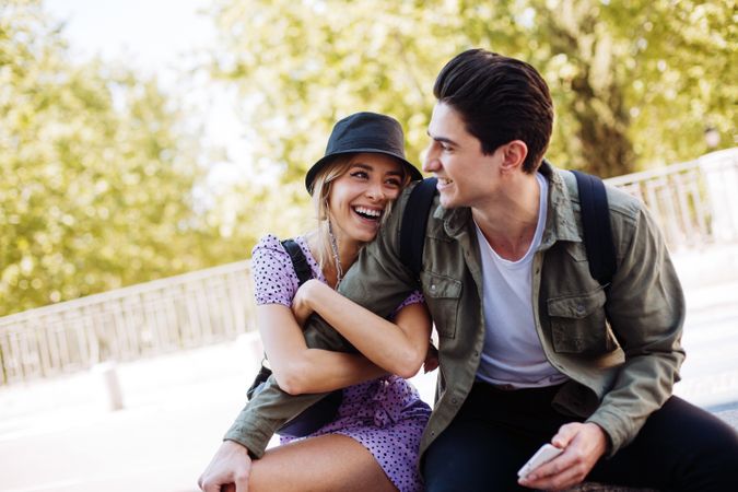 Happy couple having fun sitting in the street
