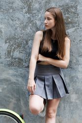 Woman leaning on grey wall background