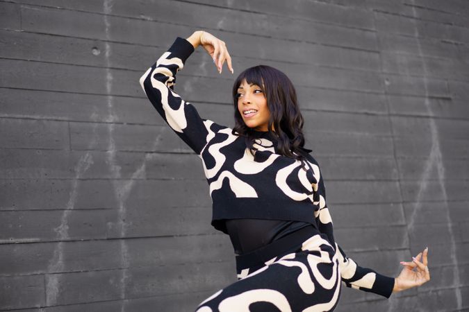 Expressive modern dancer smiling while performing in the city