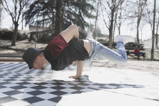 Man dancing break dance in park