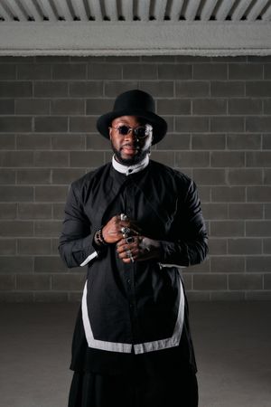 Black man standing in dark room