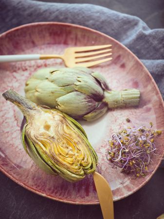 Plate with tasty artichokes and herbs