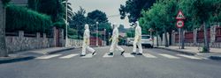 People in bacteriological protection suits walking down an empty street