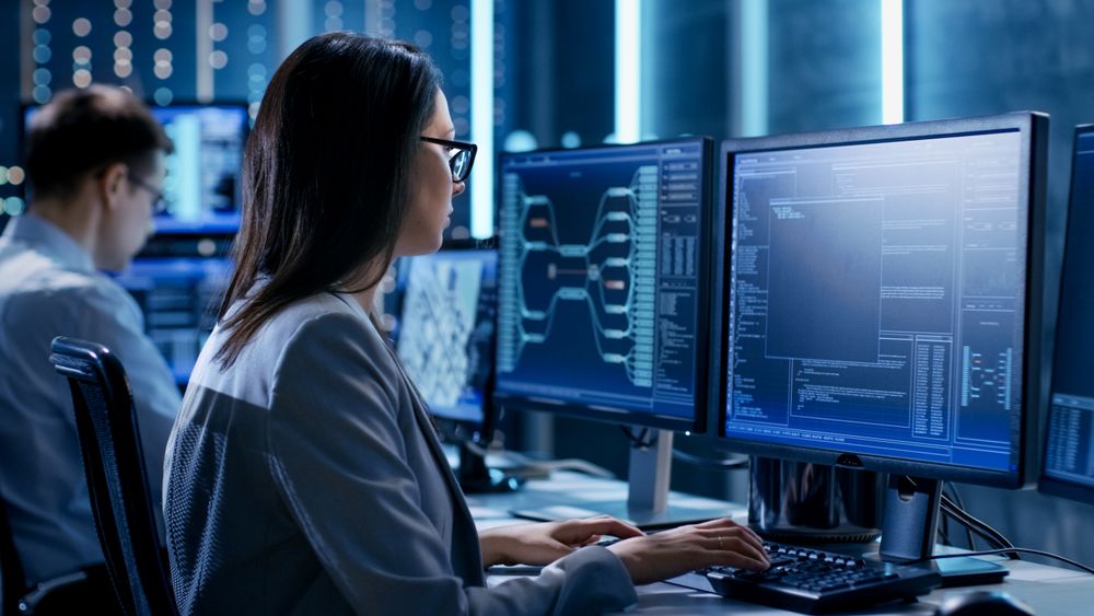 Over The Shoulder Footage of Female IT Engineer Working in Monitoring Room